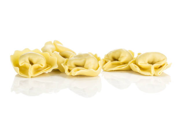 istock Fresh Raw Tortelloni stuffed pasta isolated on white 975878914