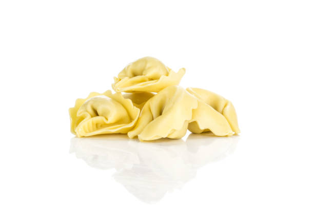 istock Fresh Raw Tortelloni stuffed pasta isolated on white 975879042