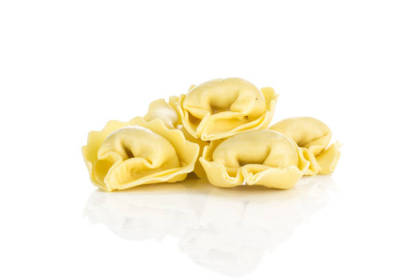 istock Fresh Raw Tortelloni stuffed pasta isolated on white 975879094