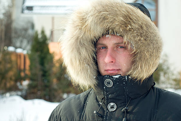 istock Winter - man in warm jacket with furry hood 97588418