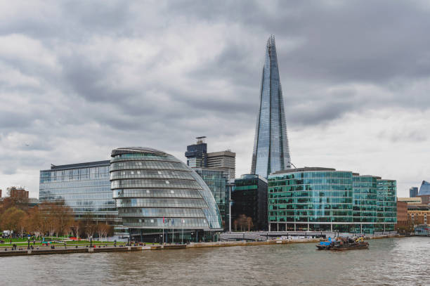 the curved glass building in spherical shape of the city hall of london and the shard, the tallest building in the uk, iconic architectural landmarks of london located on the southwark bank of the river thames near tower bridge, england - tower london england greater london inner london imagens e fotografias de stock