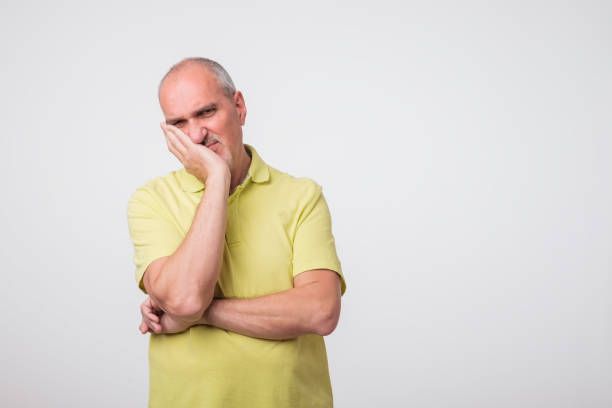 istock mature caucasian man thinking pensive looking up studio portrait. 975901726