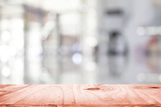 istock empty brown wooden table and interior blur background with bokeh image, for product display montage. Selected focus 975904300
