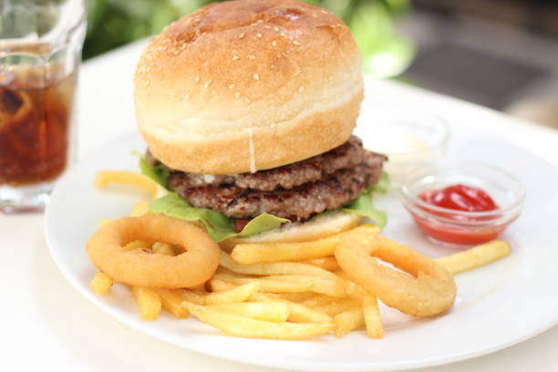 istock Young man eating an Hamburger 975912260