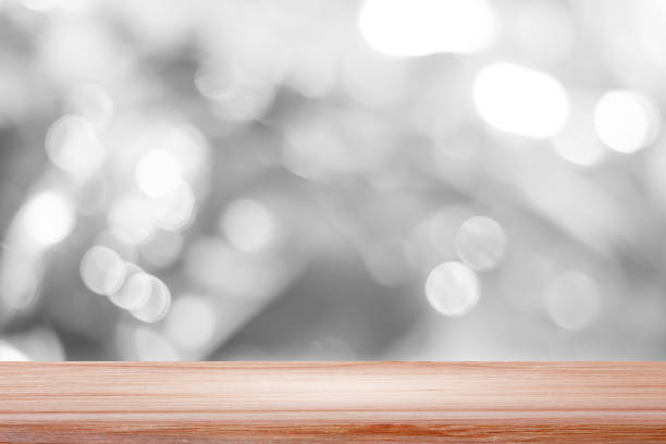 istock empty wooden on white blurred nature backdrop. Wood table top. can used for display or montage your products 975912332
