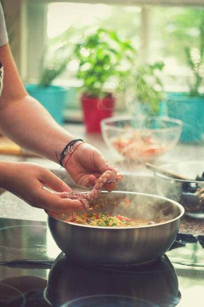 istock Young Woman Cooking at Home 975913310