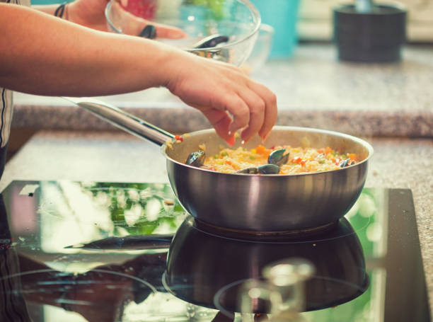 istock Young Woman Cooking at Home 975913736