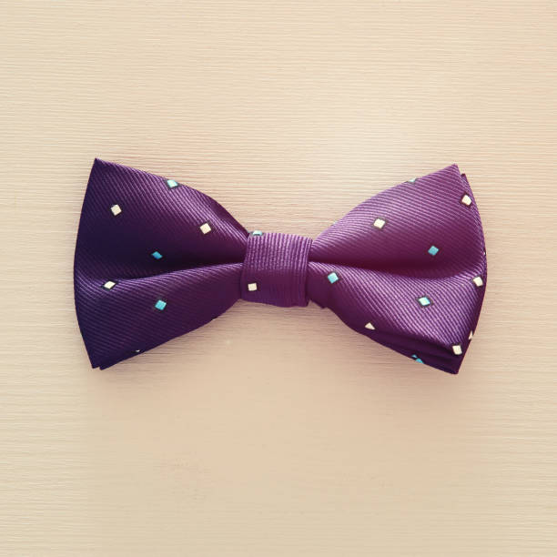istock Top view of fabric male bowtie over blue background. 975932684