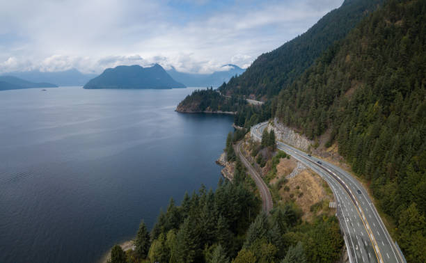 Sea to Sky Highway Aerial drone panoramic view of Sea to Sky Highway during a bright summer day. Taken North of Vancouver, British Columbia, Canada. inlet photos stock pictures, royalty-free photos & images