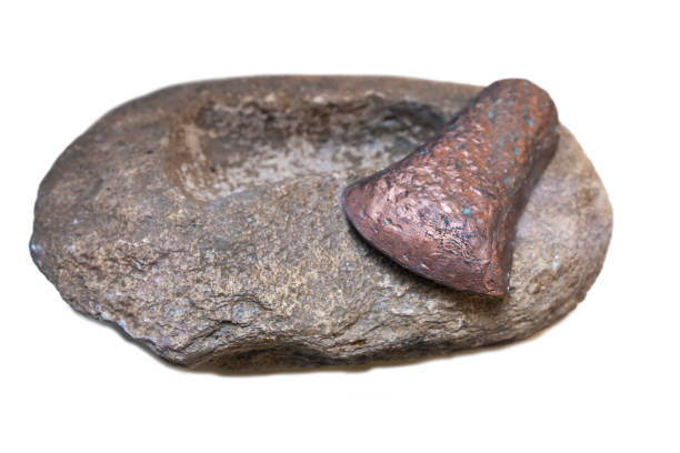 istock Stone carved axe-head mould and copper piece 975962938