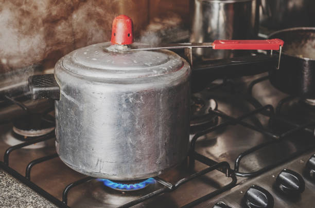 istock Cooking beans on the pressure cooker. 975971900