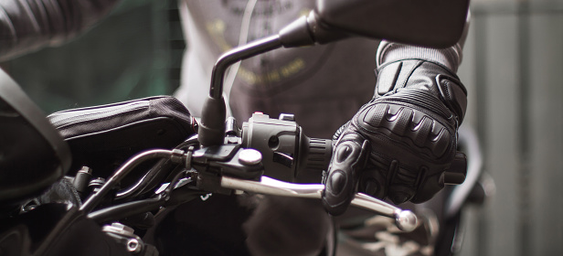 Moto gloves and motorcycle close up
