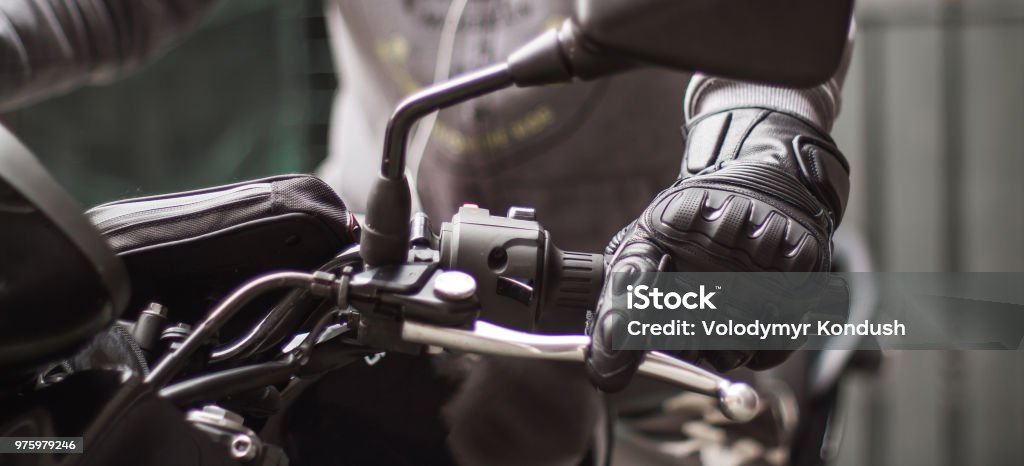 Moto gloves and motorcycle close up Motorcycle Stock Photo