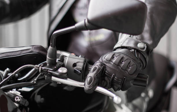 istock Moto gloves and motorcycle close up 975979260