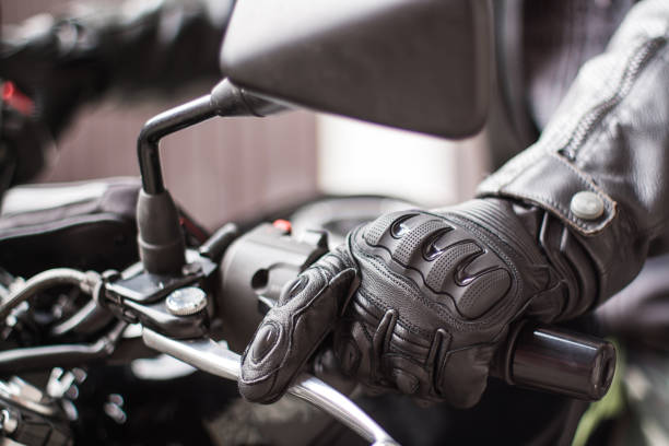 istock Moto gloves and motorcycle close up 975979290