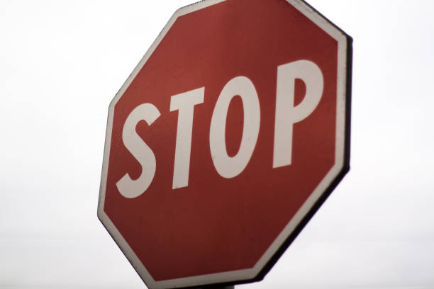 istock Stop sign in front of white backround 975979322
