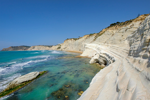 Beach with crystal blue waters in the village of Armação de Perâ, Algarve, Portugal