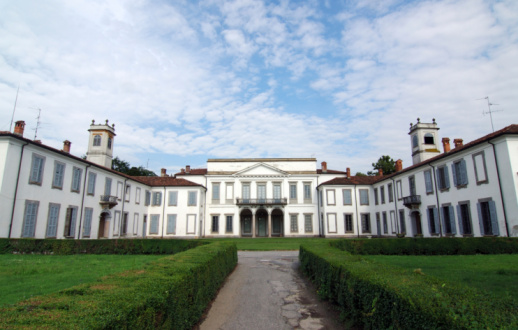 Parco di Monza (Milan, Lombardy, Italy) - Exterior of Palazzo Mirabello, white palace built in 17th century, with its garden under a dramatic sky