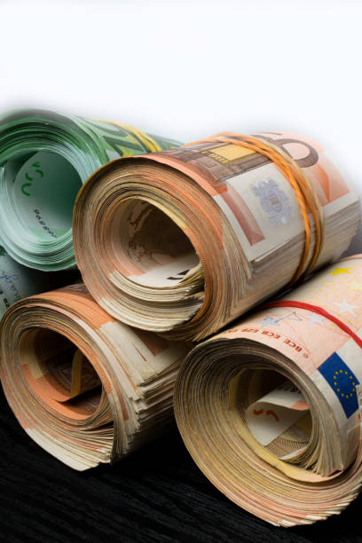 istock Rolled several thousand euro banknotes with rubbers background 975986776