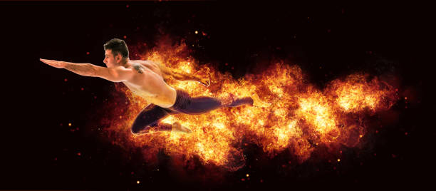 istock Man flying as superhero through the air with flames and fire 975992436