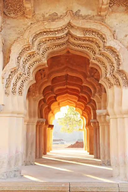 Lotus Mahal Temple in Hampi, Karnataka, India. Beautiful carved stone arch and sunset. A popular tourist route from the GOA state. Beautiful hindu temple.
