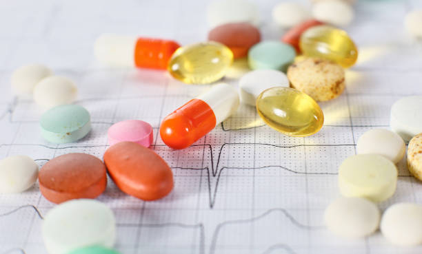 istock Colored pills poured from a brown bottle. Medical concept 975993460