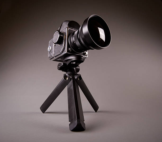istock Old photo camera with tripod on grey in Hi-Res 97599378
