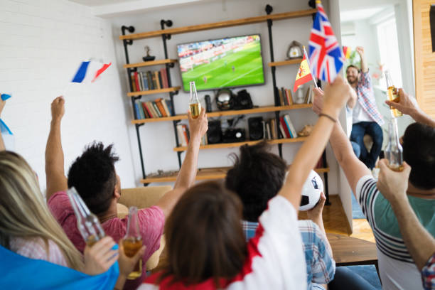 istock Group of multi-ethnic people celebrating football game 975995042