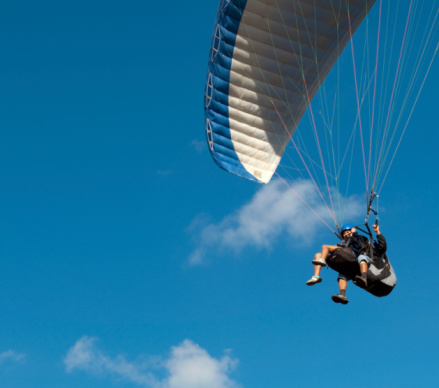 Paragliders are practicing flying in the blue sky, An Giang province, Mekong Delta