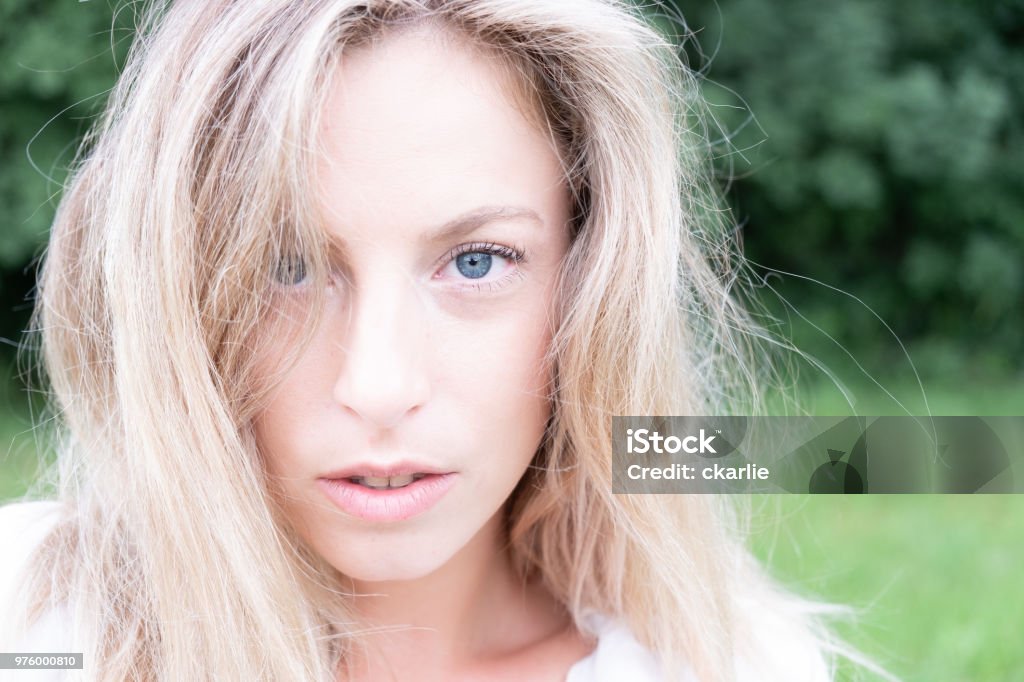 Beautiful Blonde Girl In The Garden On A Sunny Day Stock Photo