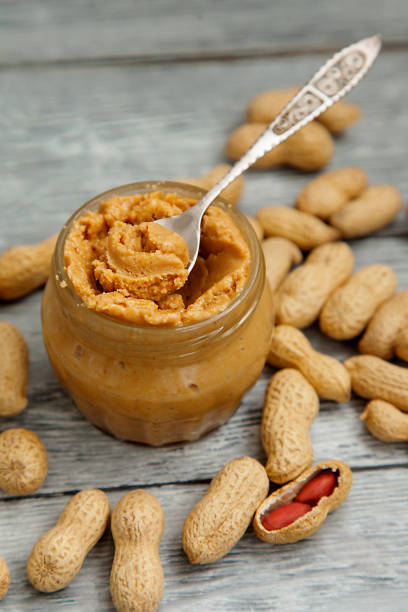 istock an open jar of peanut butter with spoon 976020900