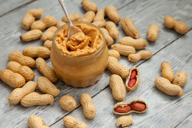 istock an open jar of peanut butter with spoon 976021924
