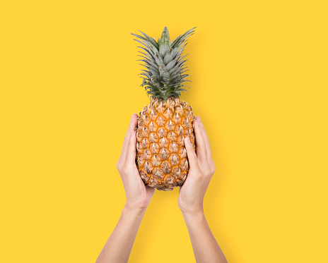 Creative Ripe pineapple on yellow background. fruit for tropical.
