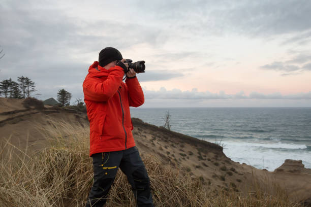 istock Photographer on the Ocean Coast 976043192
