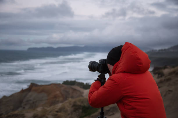 istock Photographer on the Ocean Coast 976043632