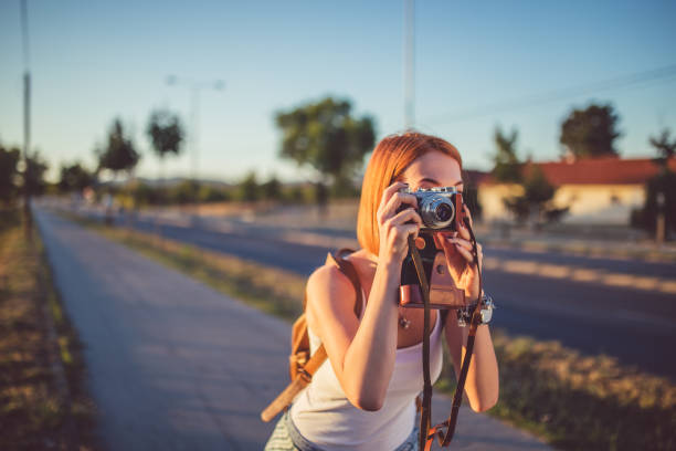 istock Woman taking picture with her retro camera. 976052472