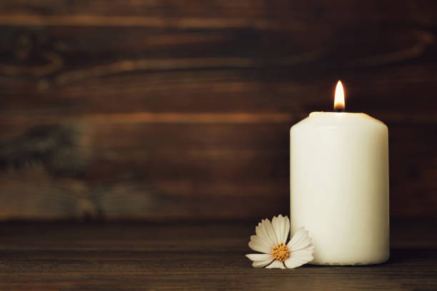 istock Condolence card with white burning candle and flower 976058020