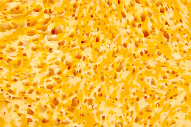 istock Texture slice of marble cheese with holes background 976076300