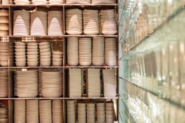 Cupboard stocked with ceramic dishes and drinking glasses