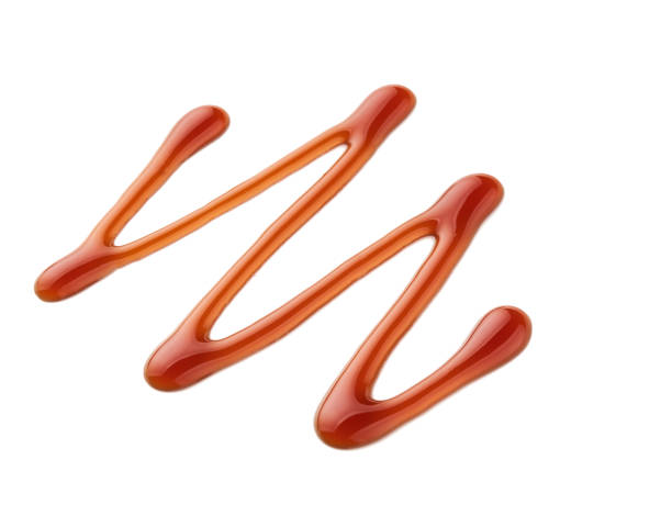 istock Sweet caramel sauce isolated on white background, top view. 976080290