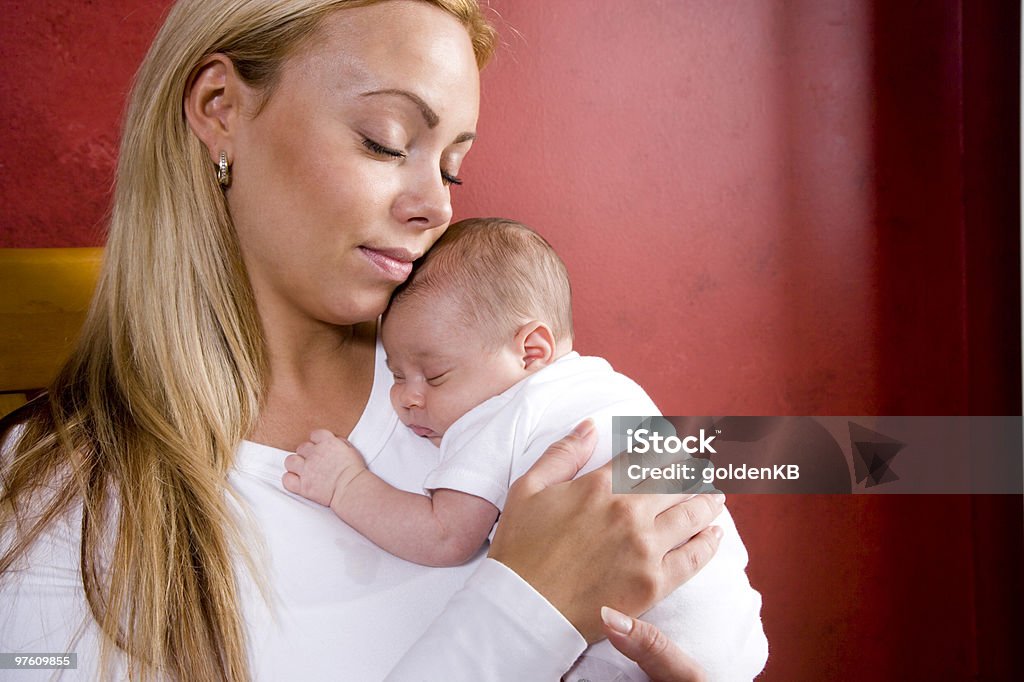Mother holding newborn baby in rocking chair  Baby - Human Age Stock Photo