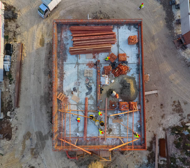 istock Construction of a brick building. Installation of the roof. Construction works. 976147724