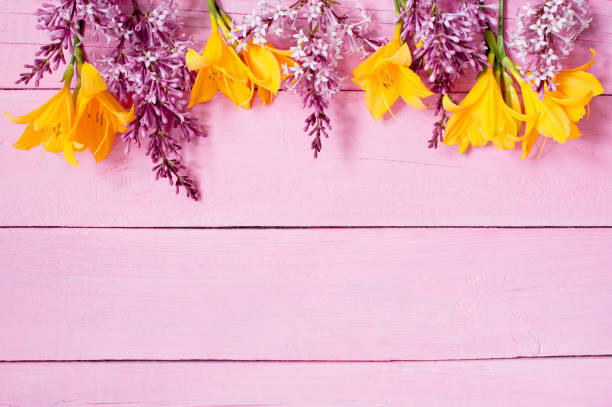 istock Pink wooden background with bright flowers 976151080