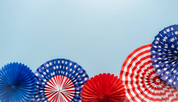 istock July 4th theme paper fans on blue background. 976155908