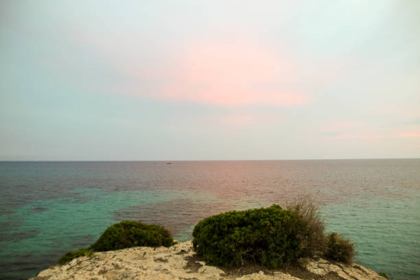 istock Rocky landscape by the sea at dusk sunset 976198286