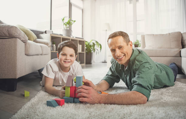 istock Glad family playing with toy in apartment 976208032