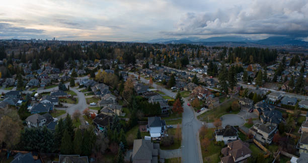 Surrey Aerial Aerial panoramic view of a suburban neighborhood during a vibrant and cloudy sunset. Taken in Greater Vancouver, British Columbia, Canada. surrey british columbia stock pictures, royalty-free photos & images