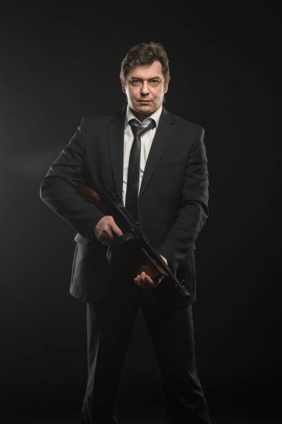 istock Handsome middle aged man gangster with Thompson machine gun 976253092