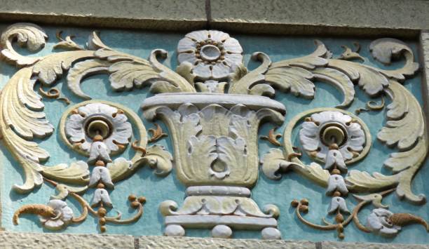 architectural scrollwork looks like an urn with ferns and flowers