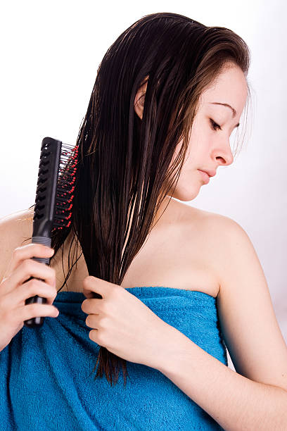 istock Woman is brushing her hair and looking down 97626845